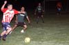 Hugo Barros of Tuxpan dribbling the ball in front of Angel Calix of Bayberry