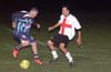 Hugo Barros of Tuxpan(left) holding the ball away from Luis Correa of Bateman(right)