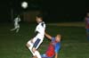 Luis Vas of Tuxpan about to head the ball as Renzo Rueda of Bateman does a slide tackle