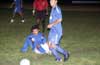 Claudio Carmago of Tuxpan on the ground watching Antonio Padilla of Maidstone passing by, both teams started play in blue