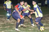 Gehider Garcia of Maidstone(left) taking a shot past Mario Robles(center) and Reynaldo Yanes of Tuxpan
