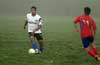 In a heavy fog, Matthew Romero of Maidstone Market(left) about to pass the ball before Uchupie Esteban of FC Tuxpan can get it