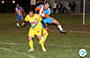 Fabian Arias of The Hideaway jumping over Luis Dominguez of FC Tuxpan to get to the ball