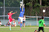 Hampton FC keeper, Olger Araya, jumping over David Rodriguez of Tortorella Pools to grab the ball