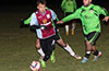 Andy Gonzalez of Maidstone dribbling between the Hampton FC defenders