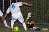 Sag Harbor keeper, Cristian Flores, trying to block a shot by a FC Tuxpan forward