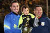 Alex Mesa holding his son and winning trophy standing next to John Romero of Maidstone Market