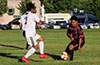 Cristian Compuzano of FC Tuxpan(right) about to go by Fredy Pedro of Sag Harbor