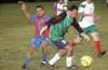 Enrique Pichardo of Tuxpan about to grab the ball from Luis Correa of Bateman(left)