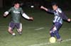 Bernabe Hernandez of Tuxpan(right) about to try to kick the ball past Angel Calix of Bayberry(left)