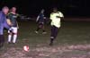 Alex Cannon of Bayberry(left) about to kick the ball into Richard Scott of Rottweilers(right), who passes it to Romulo Tubatan