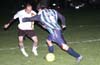 Andres Arango(#8) of Tuxpan, about to get by Rene Gutierrez of Maidstone(left)