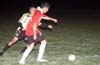 Christian Munoz of Tortorella(front) protecting the ball from Fabian Arias of the Rottweilers