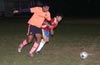 Diego Marles(left) of Maidstone and Andres Arango of Tortorella holding each other from the ball