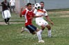 Christian Munoz of Tortorella(front) clearing the ball away from Carlos Torres of Bateman(rear)