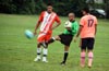 Alex Ramierz(center) kick away the spare ball as Duvan Castro(left) of Tuxpan Diego Marles of Maidstone look on