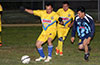 Luis Dominguez of FC Tuxpan protecting the ball from Jonathan Lizano of Bateman(right) as team mate Josue Zurdo(center) looks on