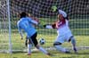 Esteban Uchupaille of Bateman Painting(left) about to kick the ball into the FC Tuxpan net as Antonio Chavez is about to block it