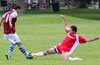 Danny Salazar of Tortorella sliding to steal the ball from Gehider Garcia of Maidstone