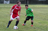 Alex George of Tortorella Pools(left) about to get by Oscar Reinoso of Hampton FC
