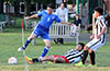 Diego Urbano of Sag Harbor sliding to push the ball out of bounds in front of the feet of Pablo Gonzalez of Bateman