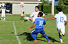 Andres Perez of FC Tuxpan(rear) trapping the ball in front of Carlos Portillo of Bateman(#10)