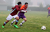 Jonathan Chunchi of Maidstone(left) and Luis Munoz of FC Tuxpan racing toward the ball