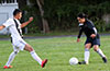Edwin Arias of East Hampton SC(right) taking on a Sag Harbor defender