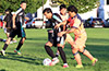 John Romero of Maidstone Market(center) trying to dribble past a couple of FC Tuxpan players