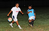 Jose Morastitla of Napoli(right) hitting the ball past Bryan Siranaula of Suchos United